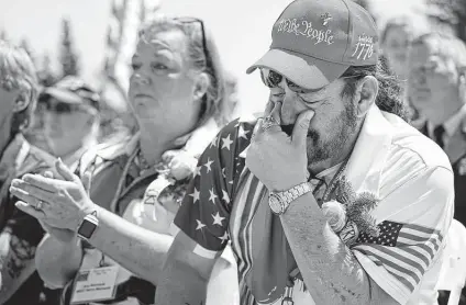  ?? Robert F. Bukaty / Associated Press ?? John Biernacki of Greenville, Texas, wipes tears during the unveiling of a monument to honor the those who died on Flying Tiger Line Flight 739. His father, Master Sgt., Henry Biernacki, was among those who died in 1962.