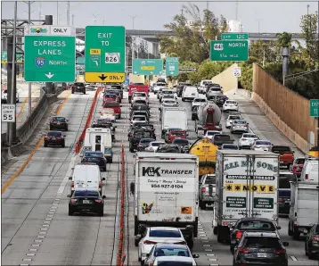  ?? JOE RAEDLE / GETTY IMAGES ?? Heavy traffic clogs I-95 in Miami. “I came to realize that commuting in Miami was the worst part of my day. Now, it’s the best part of my day,” says Parker Lake, who now paddles to work.