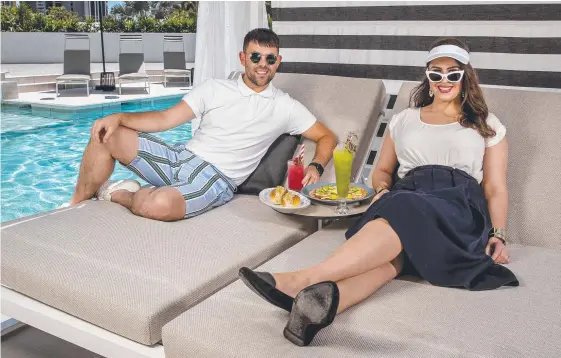  ?? Picture: JERAD WILLIAMS ?? Shaun Allen and Brianna Murphy check out the $3.5 million pool and cabana area at the QT Gold Coast Hotel in Surfers which launches today.