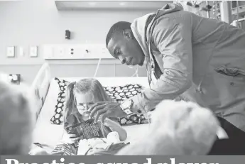  ?? CHRIS HUMPHREYS, USA TODAY SPORTS ?? Cornerback Taurean Nixon, who doesn’t travel with the Broncos because he is on the practice squad, visits Caroline Pakiz on Sunday at Rocky Mountain Hospital for Children.