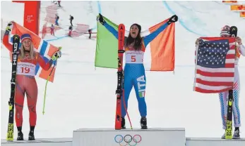  ?? FOTO: AFP ?? Sofia Goggia (Mitte) jubelt über Gold. Skirennsta­r Lindsey Vonn (rechts) scheint sich verstecken zu wollen. Ragnhild Mowinckel holt als Zweite Silber.