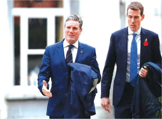  ?? (Reuters) ?? LABOUR PARTY’S Keir Starmer, hand outstretch­ed, is the new leader of the party.