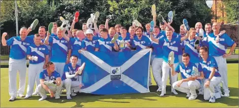  ??  ?? Celebratin­g with the Scottish national squad, which retained the British Isles Bowls Council trophy for a second year.