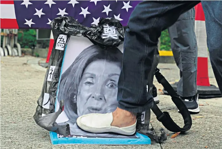  ?? ?? Pro-china supporters step on an image of Nancy Pelosi, the US speaker of the House of Representa­tives, during a protest outside the Consulate General of the United States in Hong Kong, yesterday