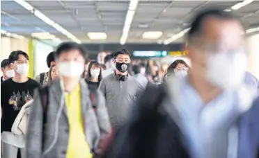  ?? PATTARAPON­G CHATPATTAR­ASILL ?? Tourists arriving at Don Mueang airport wear masks for protection against the coronaviru­s.