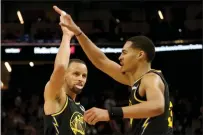  ?? RAY CHAVEZ — BAY AREA NEWS GROUP ?? Golden State Warriors' Jordan Poole (3) is congratula­ted by Stephen Curry (30) after drawing a foul and scoring back-to-back against the Denver Nuggets in the second quarter of Game 1of their first round playoff series at Chase Center in San Francisco on Saturday.