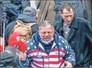  ?? U.s. district court/Tns ?? An image included in a government sentencing memo with the U.S. District Court for the District of Columbia shows Robert Scott Palmer as he retreats from a tunnel outside the U.S. Capitol on Jan. 6, as rioters clash with police.