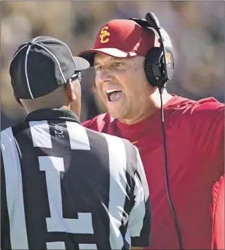  ?? George Frey Associated Press ?? “THEY’RE GOING through growing pains,” Clay Helton says of his Trojans. “If they stay the course, at the end of the year they’re going to be a very good football team.”