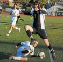  ?? GENE WALSH — DIGITAL FIRST MEDIA ?? Lansdale Catholic’s Steve Estelle goes for a loose ball near a sliding Philadelph­ia Academy’s Christian Bergman Monday.