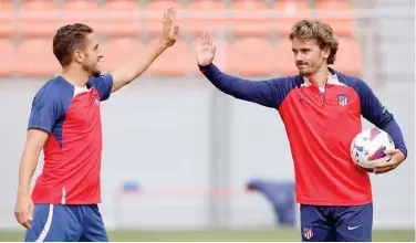  ?? Courtesy: Atletico Madrid X ?? ↑ Atletico Madrid players share a light moment during a training session ahead of their Spanish League match against Athletic Bilbao.