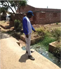  ?? ?? Mr Chirambo Kalenje shows raw sewage flowing along Chizuwi St reetin Rimuka, Kadoma