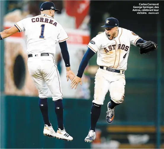  ?? PHOTO AFP ?? Carlos Correa et George Springer, des Astros, célébrant leur victoire.
