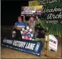  ?? RICH KEPNER - FOR MNG ?? Zeb Wise raises the winner’s check after winning the USAC Midget race at Action Track USA on July 31.