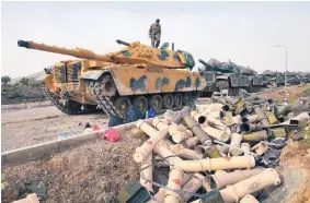  ?? LEFTERIS PITARAKIS/ASSOCIATED PRESS ?? Turkish Army soldiers prepare their tanks next to empty shells at a staging area on the outskirts of the village of Sugedigi, Turkey, on the border with Syria on Jan. 22.