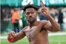  ?? Andrew Mills/NJ Advance Media via AP ?? ■ Tampa Bay Buccaneers wide receiver Antonio Brown (81) gestures to the crowd as he leaves the field while his team’s offense is on the field against the New York Jets during the third quarter of an NFL game Sunday in East Rutherford, N.J. Brown left the game and did not return.