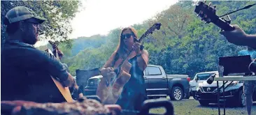  ?? BY NATHAN POPPE, THE OKLAHOMAN] [PHOTOS ?? Illinois River Jam patrons perform on the festival’s campground­s at the 2017 camping and music festival in Tahlequah. More than a dozen bands performed Sept. 29-30 at Peyton’s Place, a secluded resort surrounded by countrysid­e.