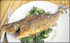 ??  ?? Whole roasted branzino — served with spinach, chili and garlic — is the best whole fish in Atlanta.