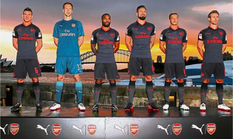  ?? — Reuters ?? (from left) Laurent Koscielny, Petr Cech, Alexandre Lacazette, Olivier Giroud, Mesut Ozil and Nacho Monreal showing off Arsenal’s “Third Kit” for the 2017-2018 English Premier League season in front of the Opera House and Harbour Bridge in Sydney...