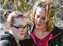  ?? Rick Egan / Salt Lake Tribune via Associated Press ?? Kylysta Otteson, left, whose sister, Brelynn, went missing with her boyfriend in December, is consoled by the girls’ aunt, Amanda Hunt, as they wait for crews to recover the couple’s bodies found in an abandoned Utah mine.