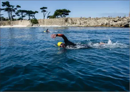  ?? PHOTOS BY DOUG DURAN — STAFF PHOTOGRAPH­ER ?? Chris Villanueva of Marina swims at Lovers Point more than three months after his friend, Steve Bruemmer, was attacked by a great white shark here. Both men are members of the Kelp Krawlers swim group, whose members are split on whether to return to ocean swimming.