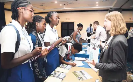  ??  ?? Students from Mount Alvernia High School in Montego Bay, St James, get informatio­n on how to apply to Bryant University in Rhode Island, United States, from Claire Dunning (right), senior assistant director, internatio­nal admissions, Bryant University,...