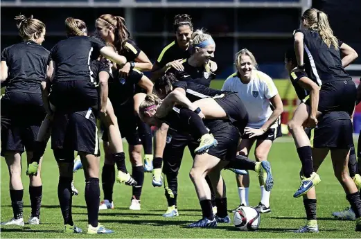  ??  ?? One more hurdle: uS players warming up during a training session at the Empire Stadium in Vancouver on Friday. The uS will meet Japan in the Women’s World Cup final today. — AFP