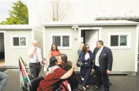  ?? Noah Berger / Special to The Chronicle ?? Mayor Libby Schaaf, who wants the county to free up more money for the city’s homeless, hugs a supporter at a Tuff Shed shelters housing site in Oakland.