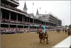  ?? The Associated Press ?? OAKS VICTORY: Jockey Florent Geroux rides to victory in the 144th running of the Kentucky Oaks Friday aboard Monomoy Girl at Churchill Downs in Louisville, Ky.