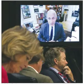  ?? (AP/Win McNamee) ?? Dr. Anthony Fauci speaks remotely Tuesday during a virtual hearing with senators. Sens. Lisa Murkowski and Rand Paul (right) were among those taking part. In a sharp exchange, Paul told Fauci that his counsel was not the only one senators would heed.