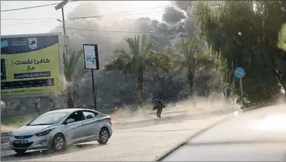  ?? KHALIL HAMRA / AP ?? Un hombre huyendo de las explosione­s causadas por la ofensiva israelí ayer en Gaza