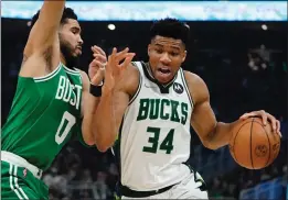  ?? MORRY GASH — THE ASSOCIATED PRESS ?? Milwaukee Bucks' Giannis Antetokoun­mpo gets past Boston Celtics' Jayson Tatum during the first half of Game 3of an NBA basketball Eastern Conference semifinals playoff series Saturday in Milwaukee.