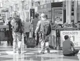  ?? Kiichiro Sato / Associated Press ?? Chicago Police SWAT team members make their way through a terminal Monday after responding to a call at Chicago’s O’Hare airport.