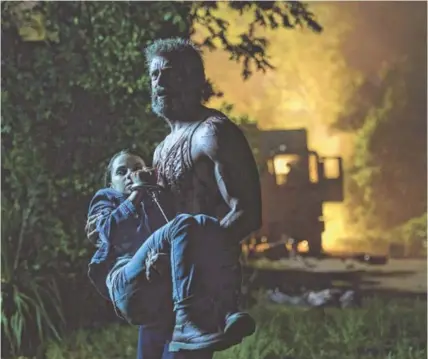  ?? BEN ROTHSTEIN/ 20TH CENTURY FOX ?? Logan/Wolverine (Hugh Jackman) tries to protect the young mutant Laura (Dafne Keen) in “Logan.”