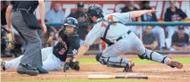  ?? GREG SORBER/JOURNAL ?? The Isotopes’ Rafael Ynoa (5) is tagged out at the plate by El Paso catcher Rocky Gale (17) in the second inning of their game Tuesday night.