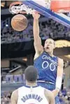  ??  ?? Magic forward Aaron Gordon throws down a dunk over Pistons center Andre Drummond during Wednesday night’s loss.