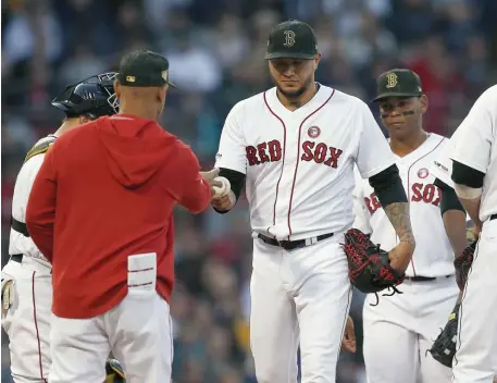  ?? ASSOCIATED PRESS ?? EARLY NIGHT: Hector Velazquez hands the ball to manager Alex Cora after getting roughed up in the first inning last night at Fenway as the Red Sox dropped a 7-3 decision to the Astros.