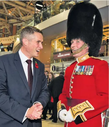  ??  ?? Gavin Williamson, 41, the new Defence Secretary, shows his support for London Poppy Day at Waterloo Station yesterday