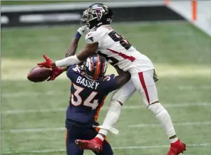  ?? John Bazemore The Associated Press ?? Atlanta receiver Russell Gage can’t come up with the catch against Denver defensive back Essang Bassey. The Broncos clawed back from an early deficit, only to come up short at the end.