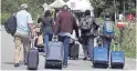  ??  ?? A family from Haiti after crossing the U.S.-Canada border in Quebec, between official ports of entry.