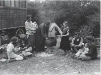  ??  ?? FAR LEFT Apple picking in East Anglia in the 1970s LEFT A Romany family gathers for meal time, c1930 BELOW Songs, celebratio­ns and ceremony: Gypsy families and friends gather for a wedding in Middlesex in 1934