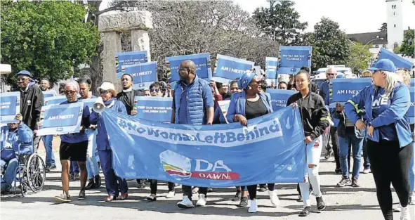  ?? Picture: SID PENNEY ?? MARCHING FOR CHANGE: DA leaders, members and supporters march down High Street in Makhanda on their way to Church Square last Friday. They were making their voices and feelings known about the violence against women and children in SA