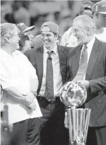  ?? GARY CORONADO/TNS ?? owner Micky Arison, left, head coach Erik Spoelstra and President Pat Riley celebrate an NBA championsh­ip in 2012.