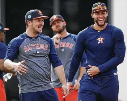  ?? Karen Warren / Houston Chronicle ?? In the spring a young man’s fancy lightly turns to … baseball as Astros outfielder George Springer, right, shares a laugh with infielder Alex Bregman as they prepare to work out with the position players at The Ballpark of the Palm Beaches.