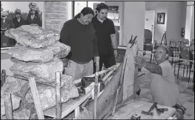  ?? TRURo daiLy nEWS FiLE PHoto ?? Mi’kmaw canoe builder Todd Labrador, right, and several interns used rocks to shape the gunwales of the birch bark canoe they built at the Millbrook Cultural and Heritage Centre. The canoe was on display at the Mi’kmaw Summer Games on the Wagmatcook...