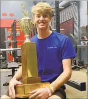  ?? Eric Sondheimer Los Angeles Times ?? TAFT HIGH quarterbac­k Wellington Bristow holds the City Section Division III championsh­ip trophy.