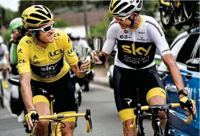  ??  ?? Mixed messages: Thomas (left) and Froome, sporting Sky’s environmen­tal campaign last July