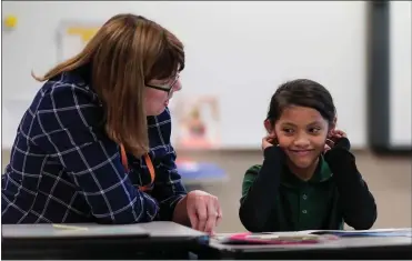  ?? PHOTOS BY RANDY VAZQUEZ — STAFF PHOTOGRAPH­ER ?? Aleena, a second-grader at San Antonio Elementary in San Jose, smiles during a session with volunteer Debbie Dawkins during the Reading Partners program. “It’s amazing to watch these kids bloom and blossom,” Dawkins said.