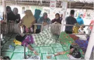  ?? Amanda Jufrian / AFP / Getty Images ?? Two Rohingya women are treated at a temporary shelter after landing on Sumatra island.