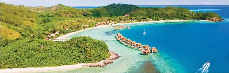  ??  ?? An aerial view of Likuliku Island Resort. Over-water bures give a feeling of being adrift.