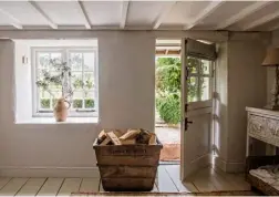  ??  ?? THIS PAGE, LEFT White-painted floorboard­s and ceiling beams maximise the space in the hallway, which was originally the kitchen MIDDLE The mirror from an old chest of drawers has been set on top of a painted table from one of Samantha’s favourite shops, The Sea Garden in Portscatho; the sofa covers were made from dust sheets, meaning they’re durable and dogproof BOTTOM The little thatched summerhous­e has its own woodburnin­g stove and terrace area